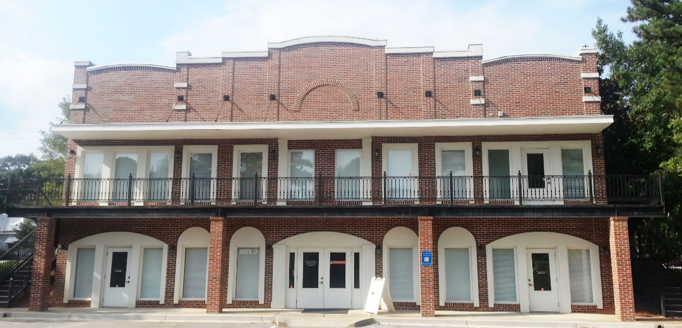 Premier Oral & Maxillofacial Surgery & Dental Implants front of the large brick building with lots of windows