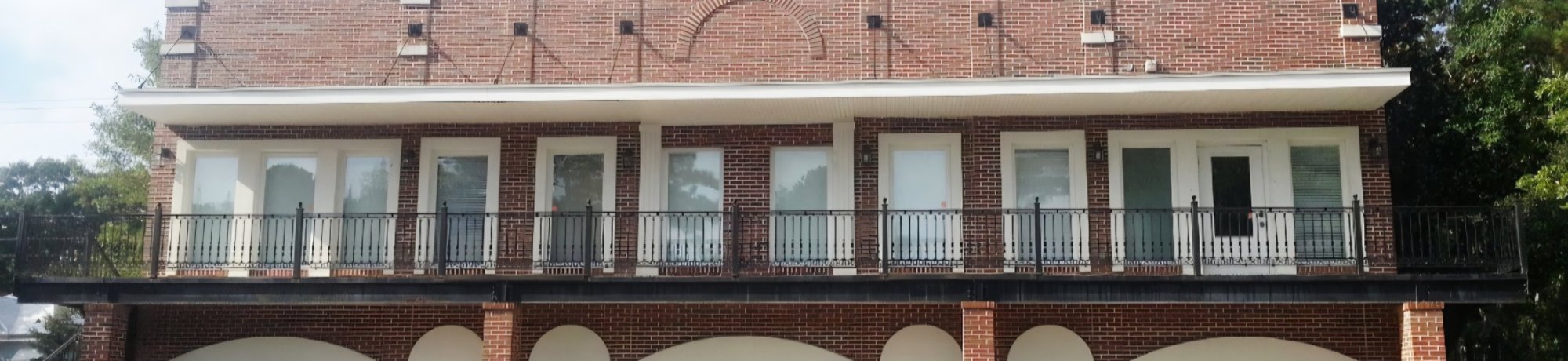 Premier Oral & Maxillofacial Surgery & Dental Implants front of the large brick building with lots of windows